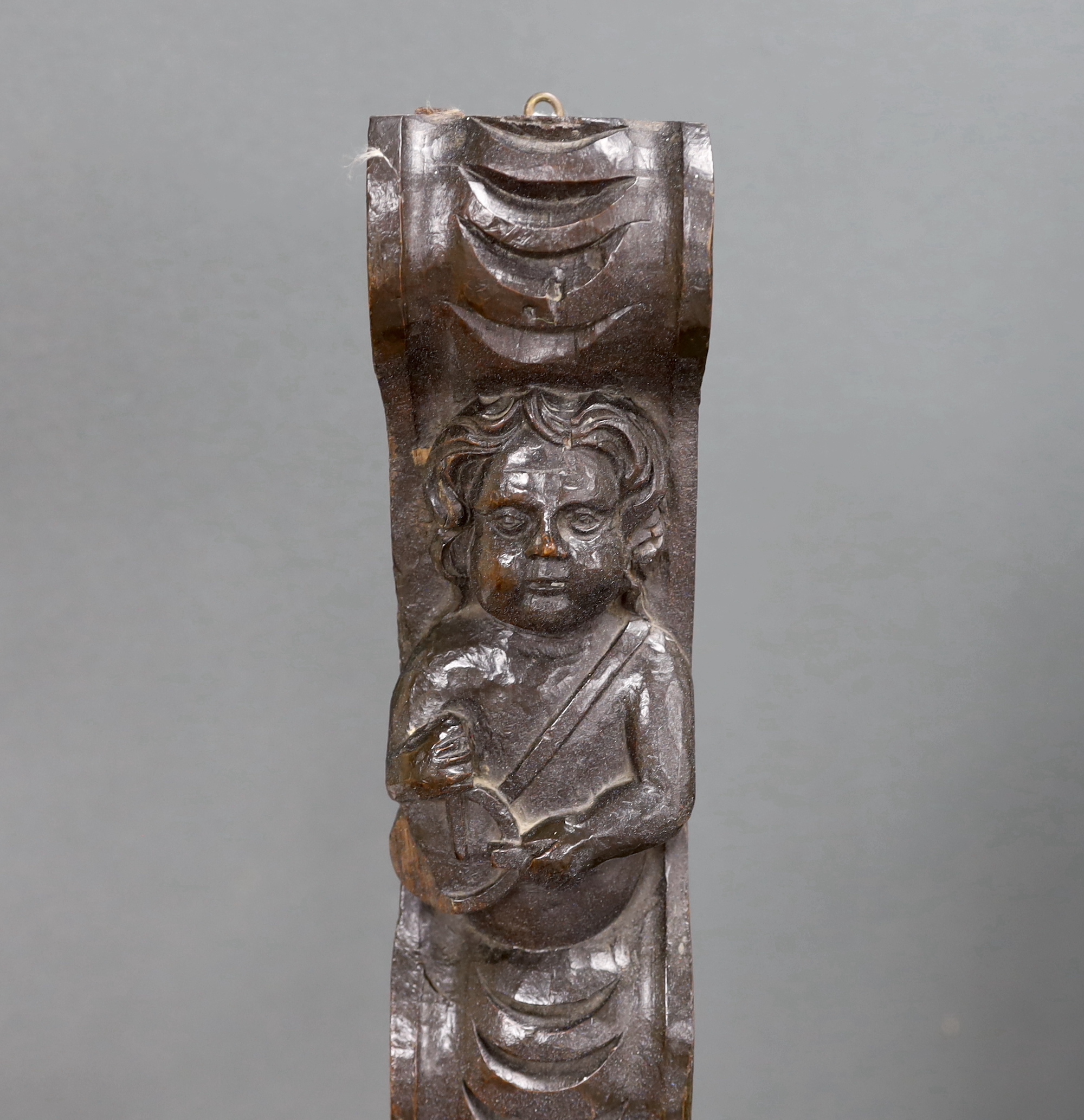 An 18th century carved oak figural pilaster, 83cm long